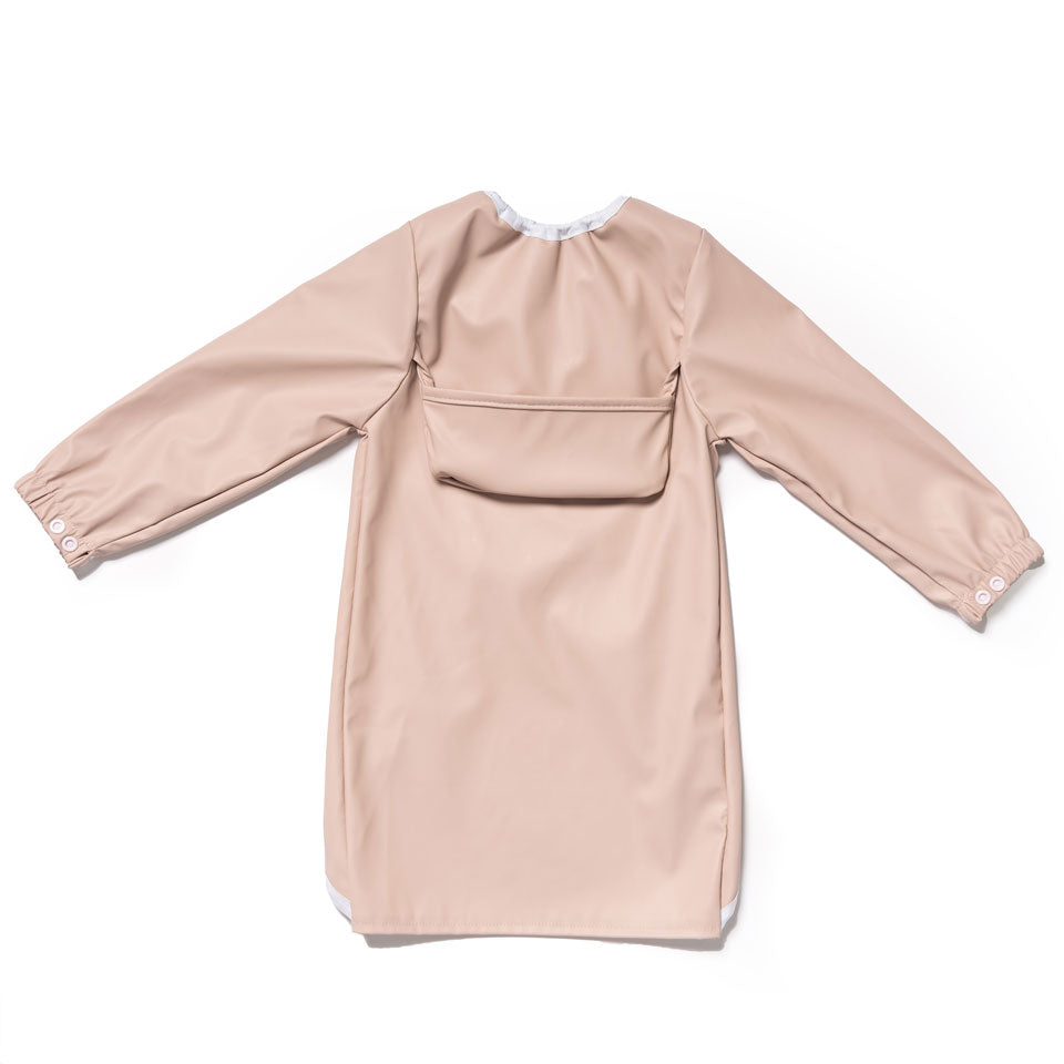 Long sleeve feeding bib in Dusty Pink with adjustable wrist cuffs to prevent food from going up sleeves.