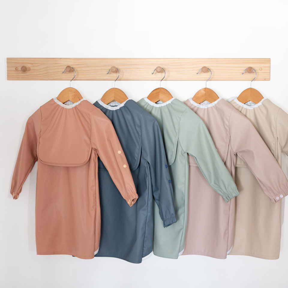 Range of waterproof long sleeve baby bibs in 5 stylish colours featuring extra long coverage and adjustable cuffs.