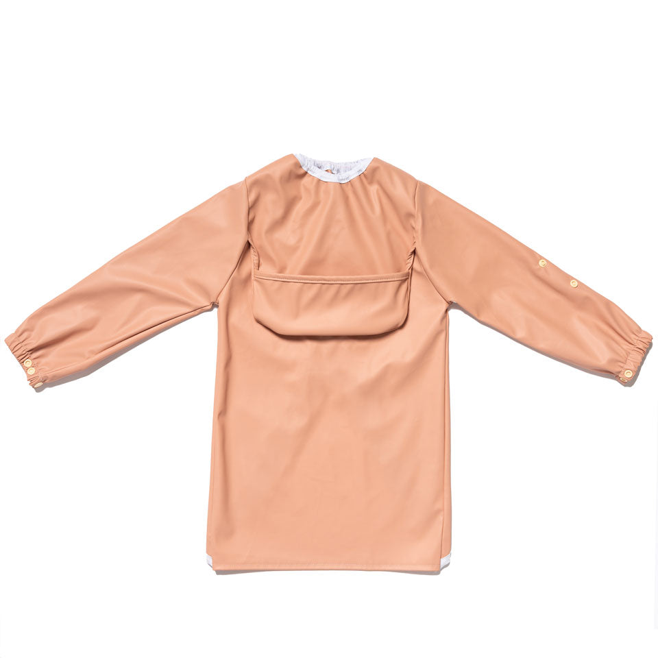 Premium waterproof baby smock in Terracotta with a fully lined chest-height pocket for easy cleaning.
